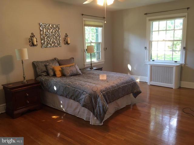 4419 Underwood Road Baltimore, MD 21218 - Photo 17 of 30 a bedroom with a bed and wooden floor