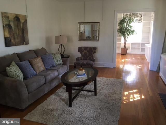 4419 Underwood Road Baltimore, MD 21218 - Photo 4 of 30 a living room with furniture and a painting on the wall