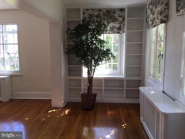 4419 Underwood Road Baltimore, MD 21218 - Photo 6 of 30 a view of empty room with wooden floor and fan