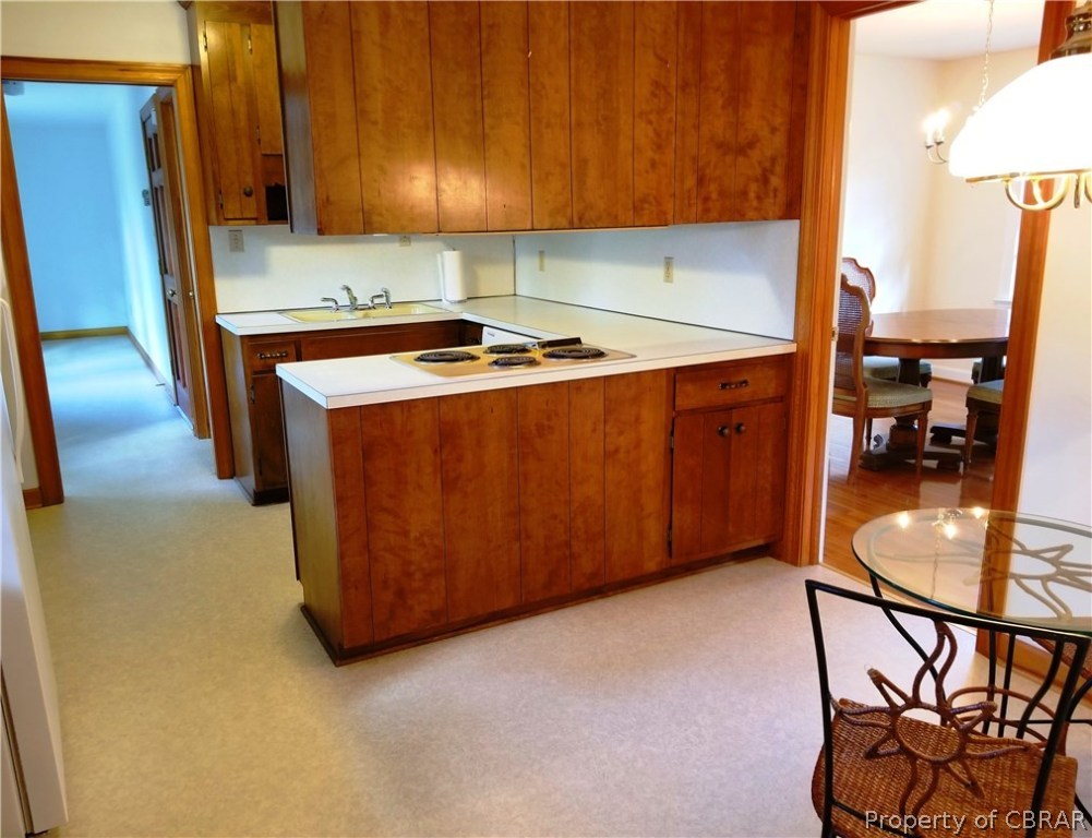 7449 Joseph Lewis Road Hayes, VA 23072 - Photo 7 of 32 Kitchen offers breakfast area and access to dining room as well as laundry/utility room & doors to garage, basement, & deck.