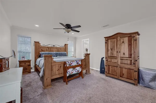 a living room with furniture and a baby crib
