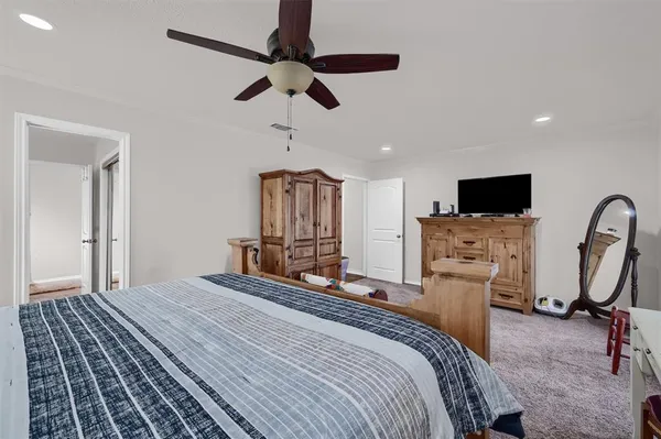 a bedroom with furniture and natural light