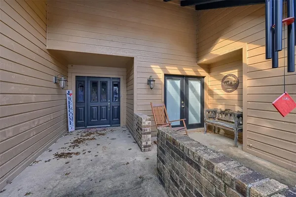 a view of a porch with a table and chairs