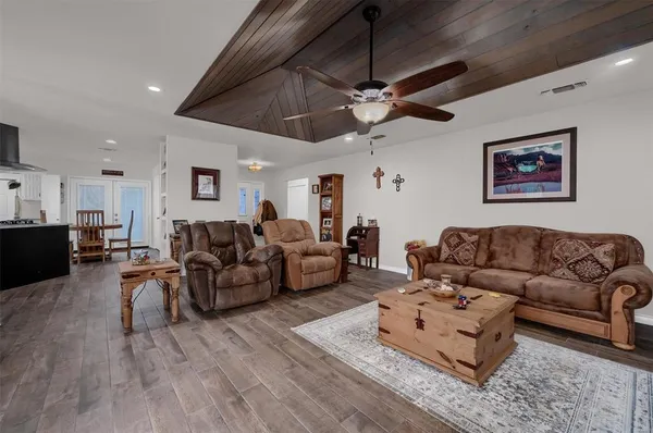 a living room with furniture and a ceiling fan