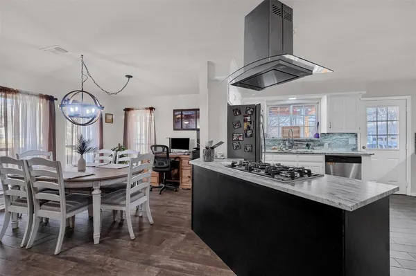a kitchen with a table and chairs in it