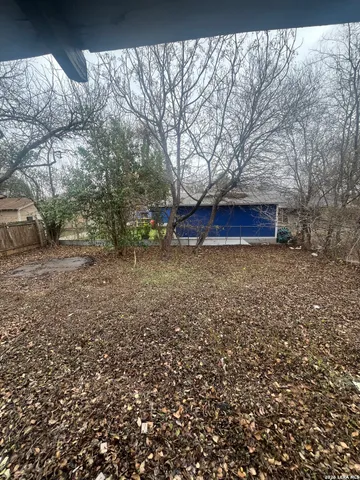 a view of house with backyard