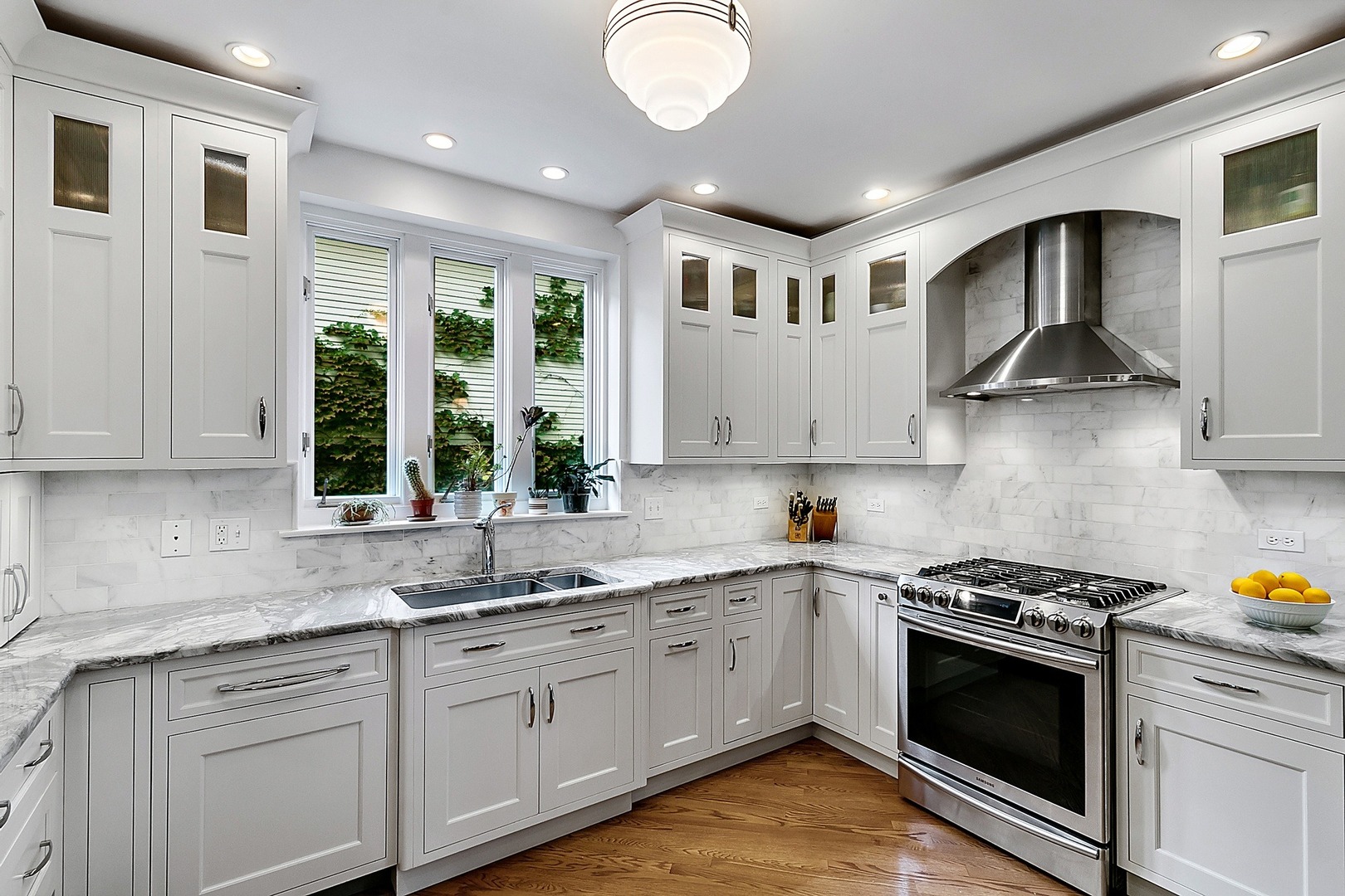 424 Uvedale Road Riverside, IL 60546 - Photo 11 of 46 a kitchen with stainless steel appliances granite countertop a stove and a sink