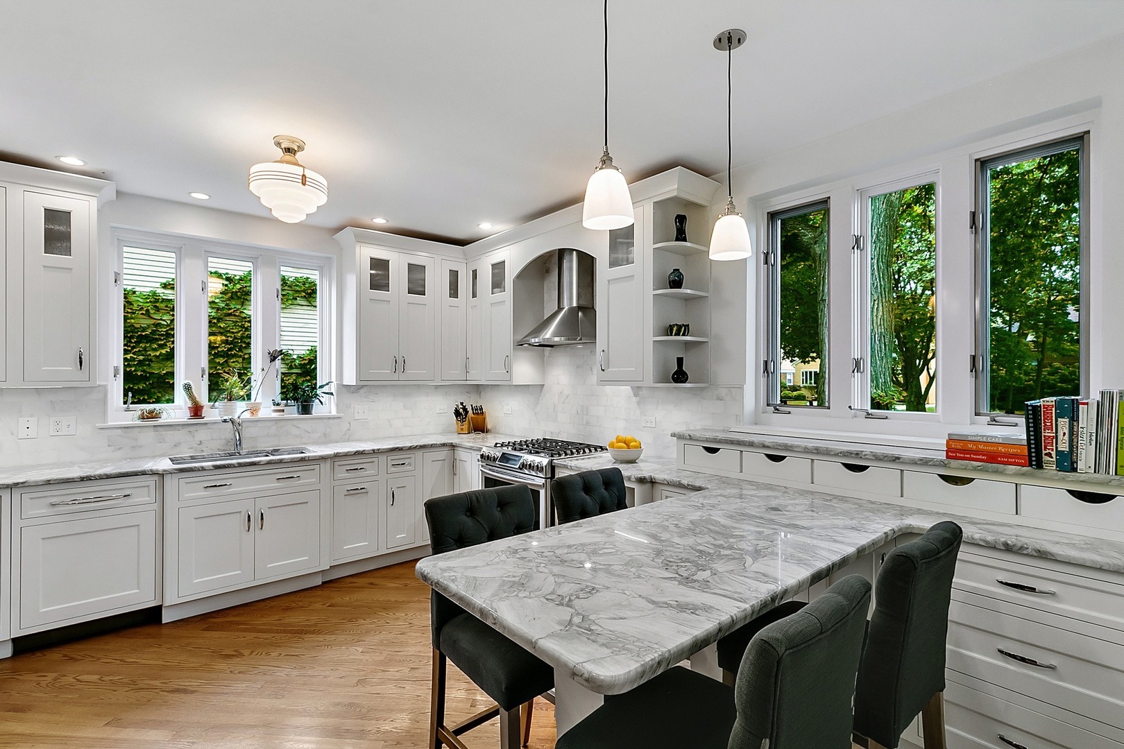 424 Uvedale Road Riverside, IL 60546 - Photo 13 of 46 a kitchen with a stove a sink a dining table and chairs