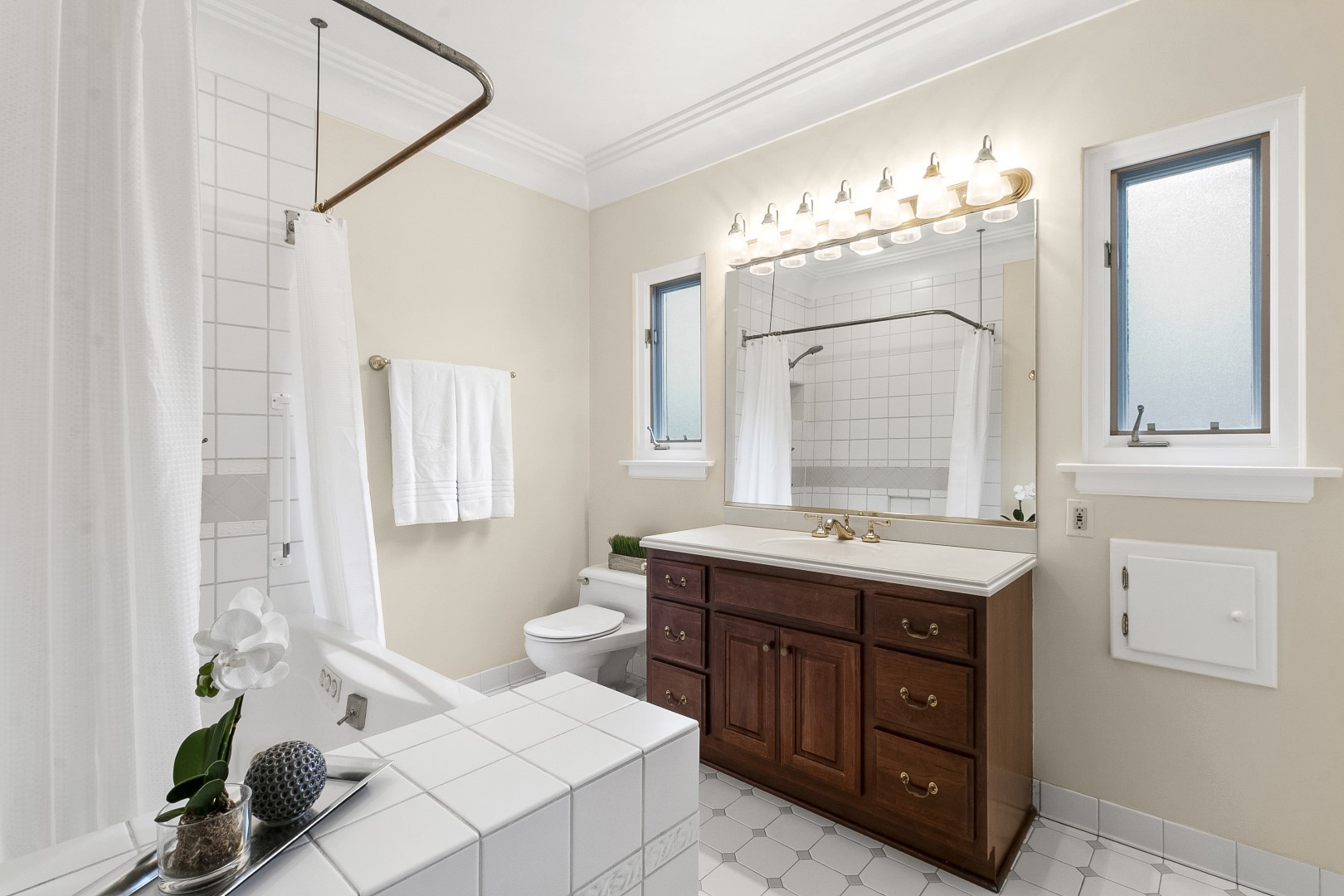 424 Uvedale Road Riverside, IL 60546 - Photo 21 of 46 a spacious bathroom with a granite countertop sink a mirror and a bathtub