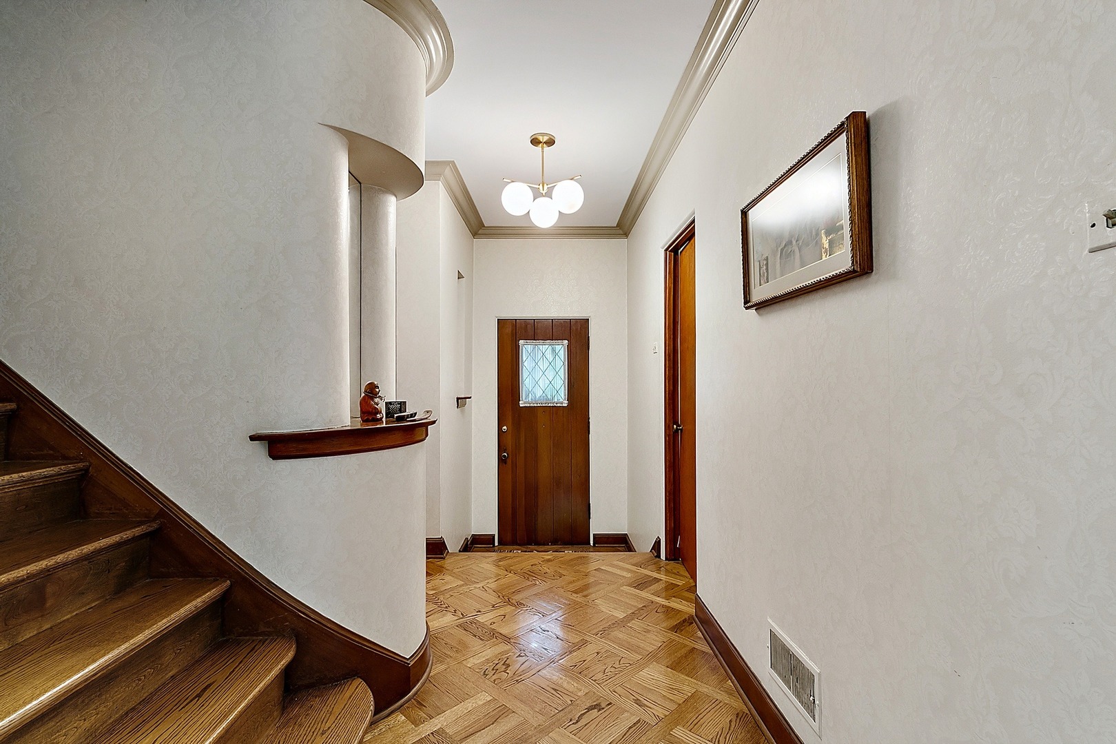 424 Uvedale Road Riverside, IL 60546 - Photo 4 of 46 a view of a hallway with wooden floor and staircase