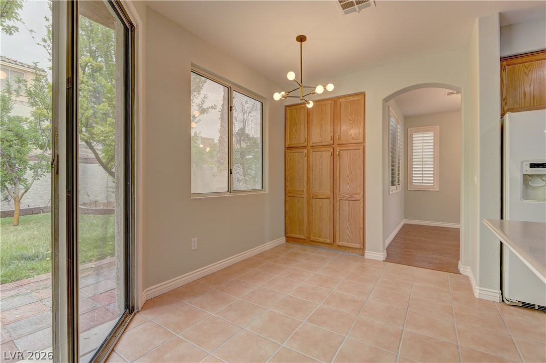 1813 Snow Spring Lane Las Vegas, NV 89134 - Photo 15 of 37 Natural light floods this versatile dining space, perfect for everyday meals or intimate gatherings.