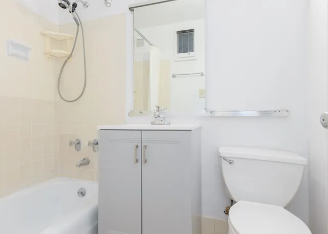 a bathroom with a sink a toilet and a mirror