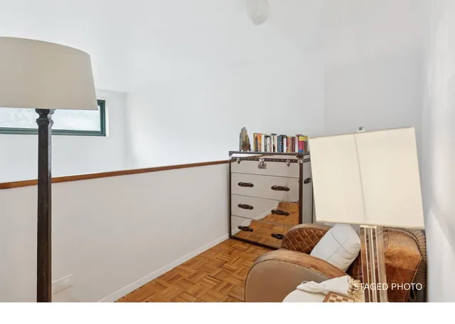 a bed sitting in a bedroom next to a window