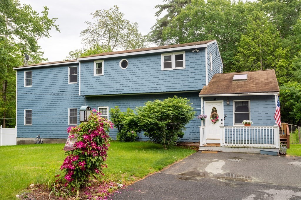 70 Valley Road Lunenburg, MA 01462 - Photo 1 of 42 a front view of a house with a garden