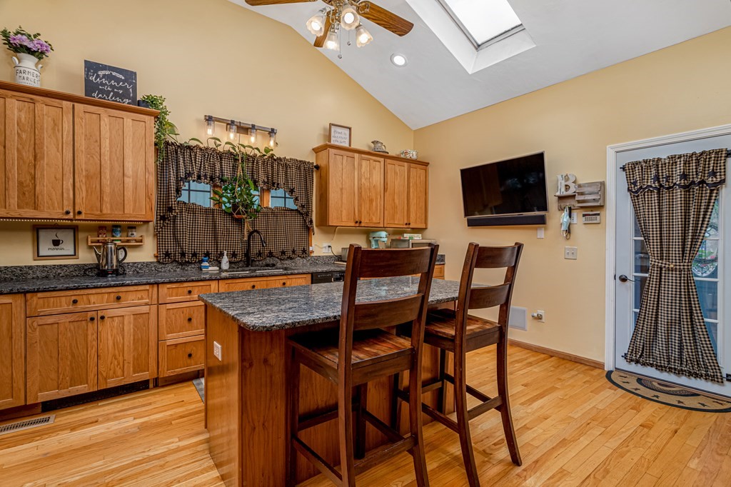 70 Valley Road Lunenburg, MA 01462 - Photo 31 of 42 a dining hall with stainless steel appliances granite countertop a kitchen island a table and chairs in it