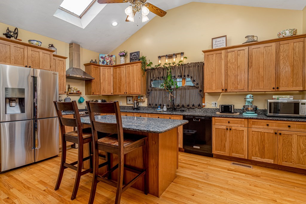 70 Valley Road Lunenburg, MA 01462 - Photo 32 of 42 a kitchen with stainless steel appliances granite countertop a table chairs sink and cabinets