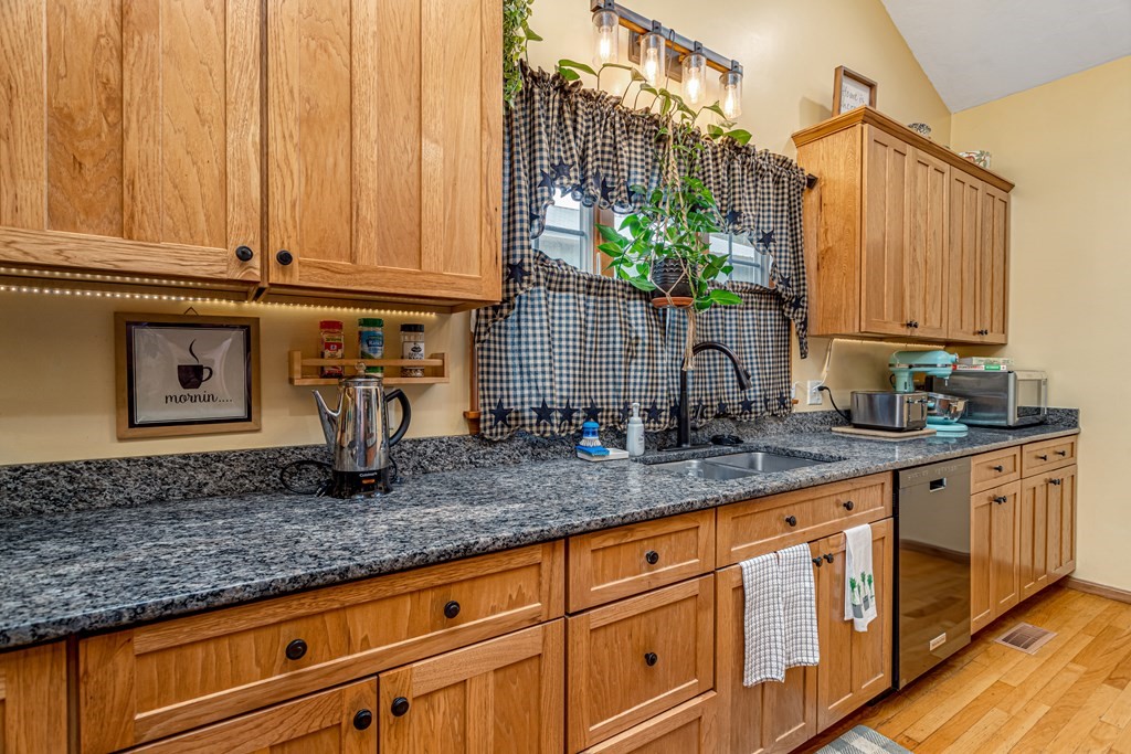70 Valley Road Lunenburg, MA 01462 - Photo 35 of 42 a kitchen with granite countertop a sink and cabinets