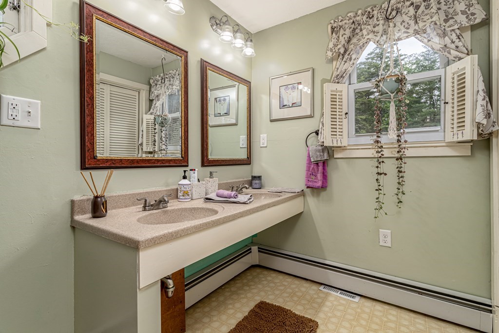 70 Valley Road Lunenburg, MA 01462 - Photo 7 of 42 a bathroom with a sink and a mirror