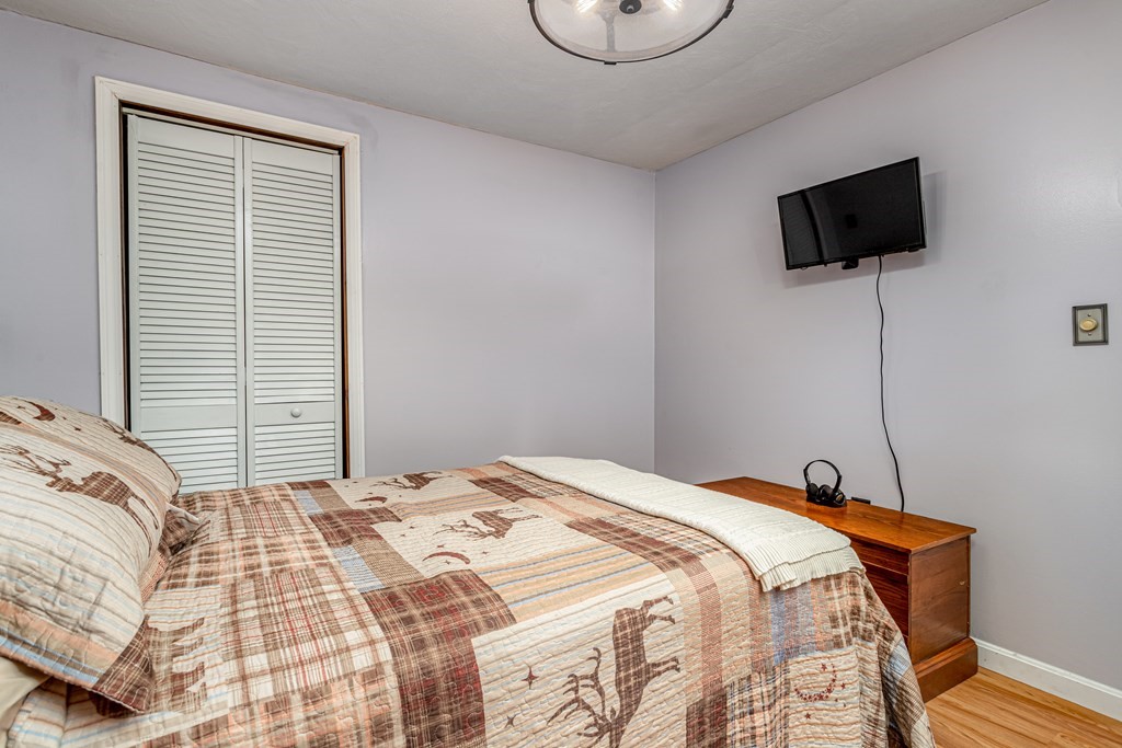70 Valley Road Lunenburg, MA 01462 - Photo 10 of 42 a bedroom with a bed a flat screen tv and a window