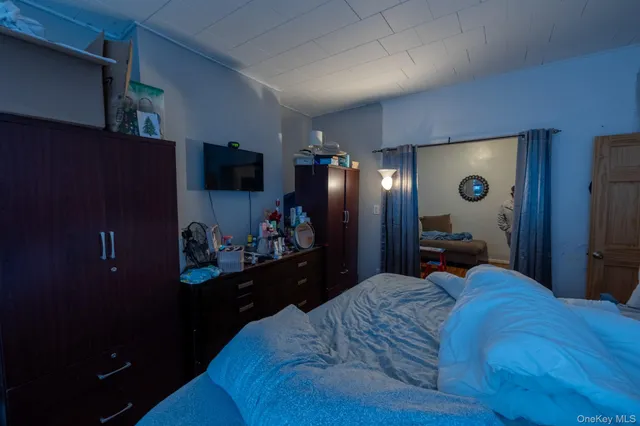 a bedroom with a bed and a television