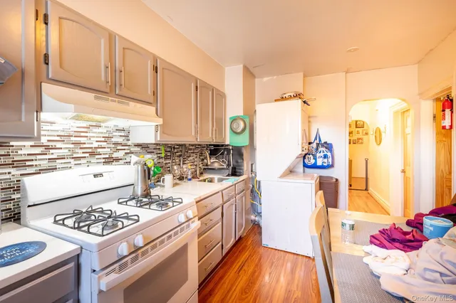 a kitchen with a stove a sink and a refrigerator