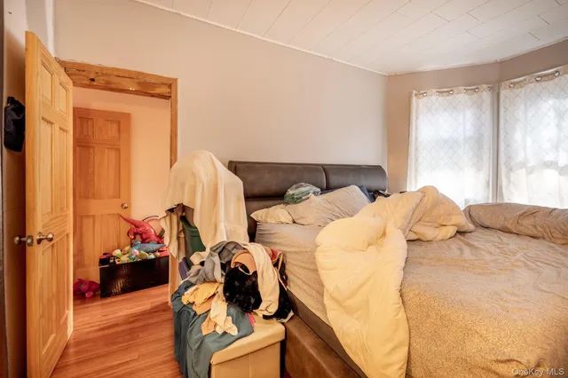 a bed sitting in a bedroom next to a window