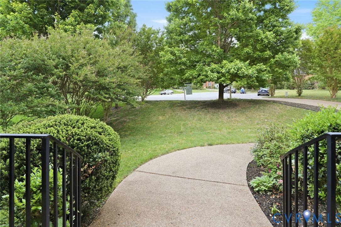 14331 Roderick Court Midlothian, VA 23113 - Photo 59 of 71 a view of a lake with a bench next to a yard