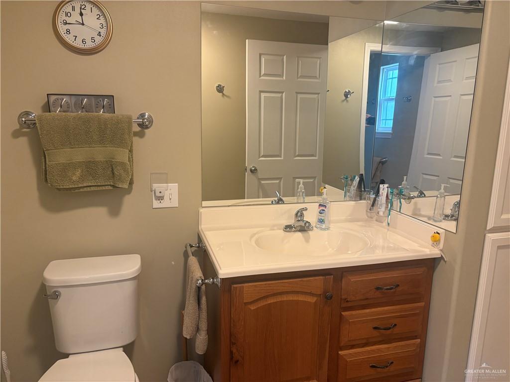 197 Laurel Road Pharr, TX 78577 - Photo 24 of 38 a bathroom with a toilet sink and mirror
