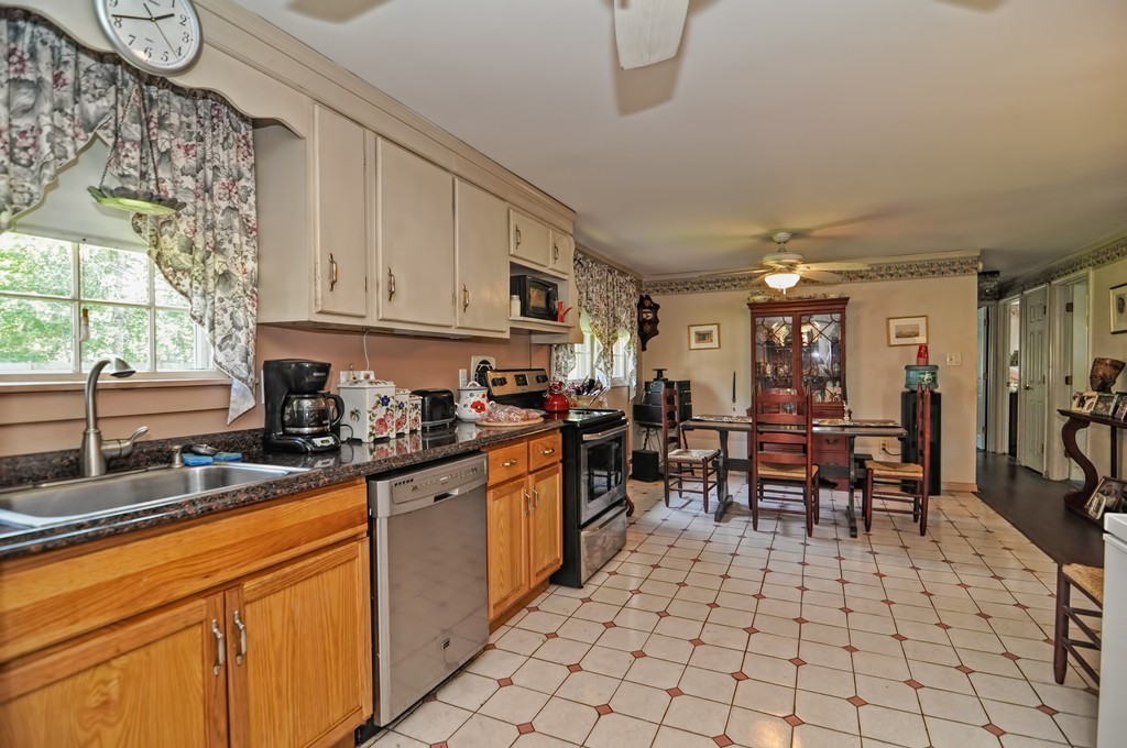 13 Sunnyvale Street Beverly, MA 01915 - Photo 13 of 25 a kitchen with stainless steel appliances granite countertop a sink and cabinets