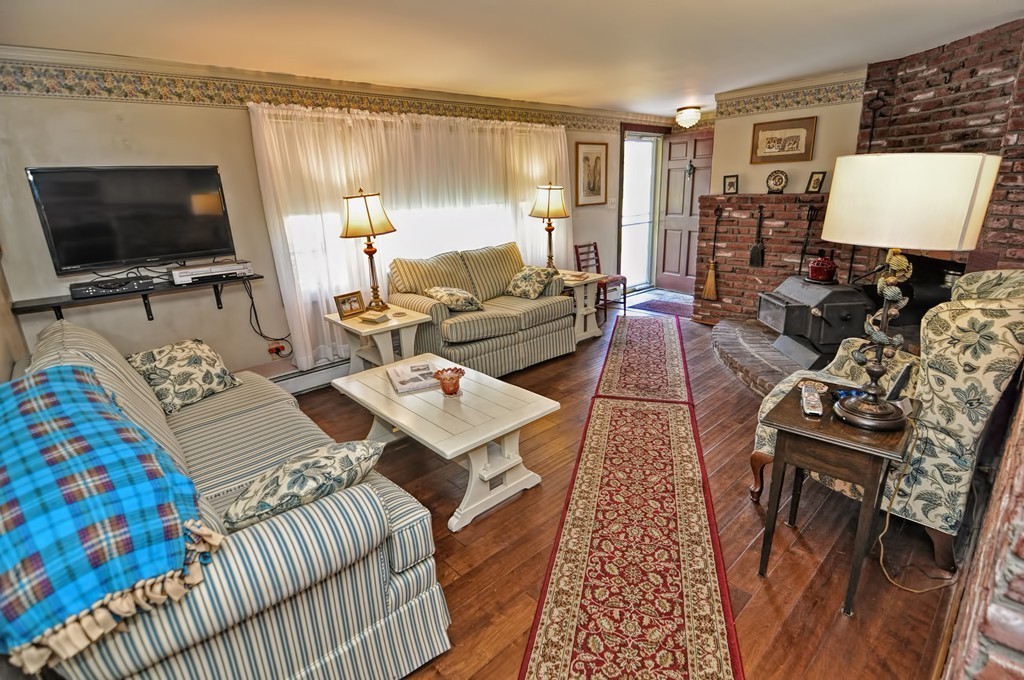 13 Sunnyvale Street Beverly, MA 01915 - Photo 16 of 25 a living room with furniture a flat screen tv and a couch