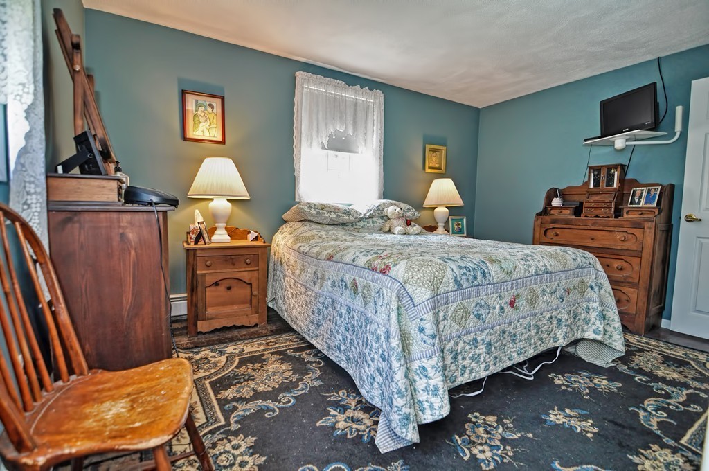 13 Sunnyvale Street Beverly, MA 01915 - Photo 18 of 25 a bedroom with a bed and wooden floor