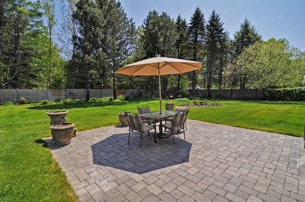 13 Sunnyvale Street Beverly, MA 01915 - Photo 6 of 25 a view of a backyard with table and chairs under an umbrella