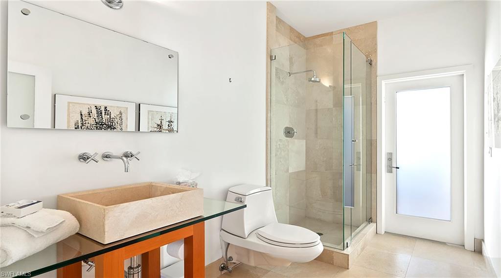 586 Yucca Road Naples, FL 34102 - Photo 18 of 26 Bathroom with a shower stall and tile patterned flooring