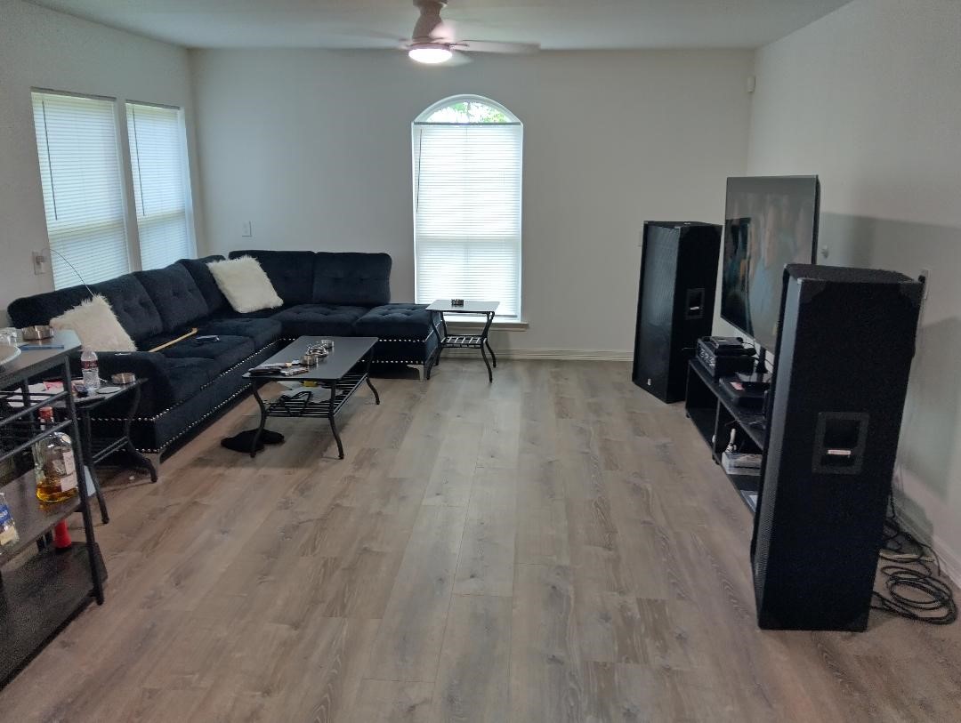 260 County Road 360 Splendora, TX 77372 - Photo 2 of 15 a living room with furniture a flat screen tv and a window