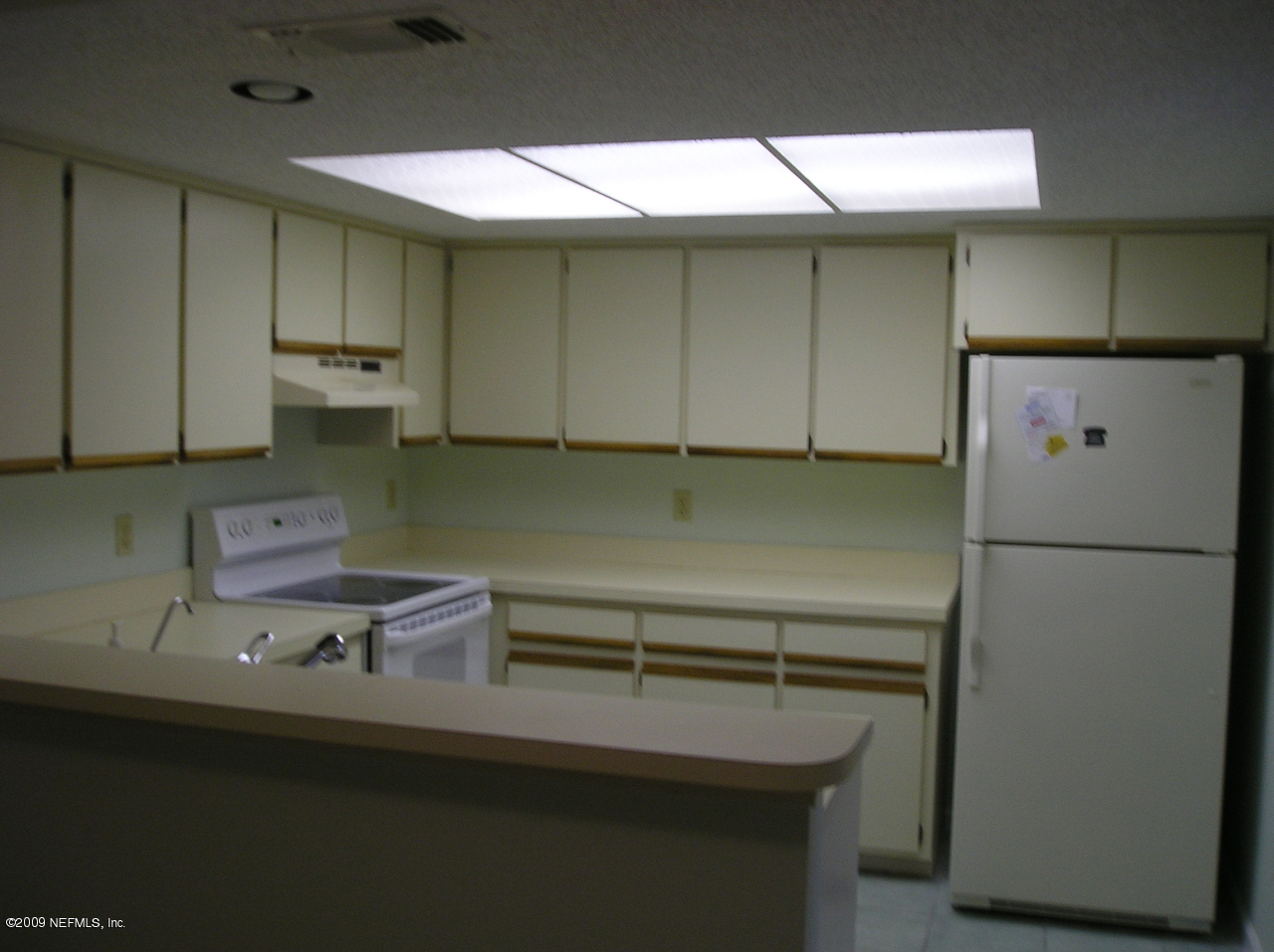 305 Tournament Road Ponte Vedra Beach, FL 32082 - Photo 5 of 9 a kitchen with a sink a refrigerator and cabinets