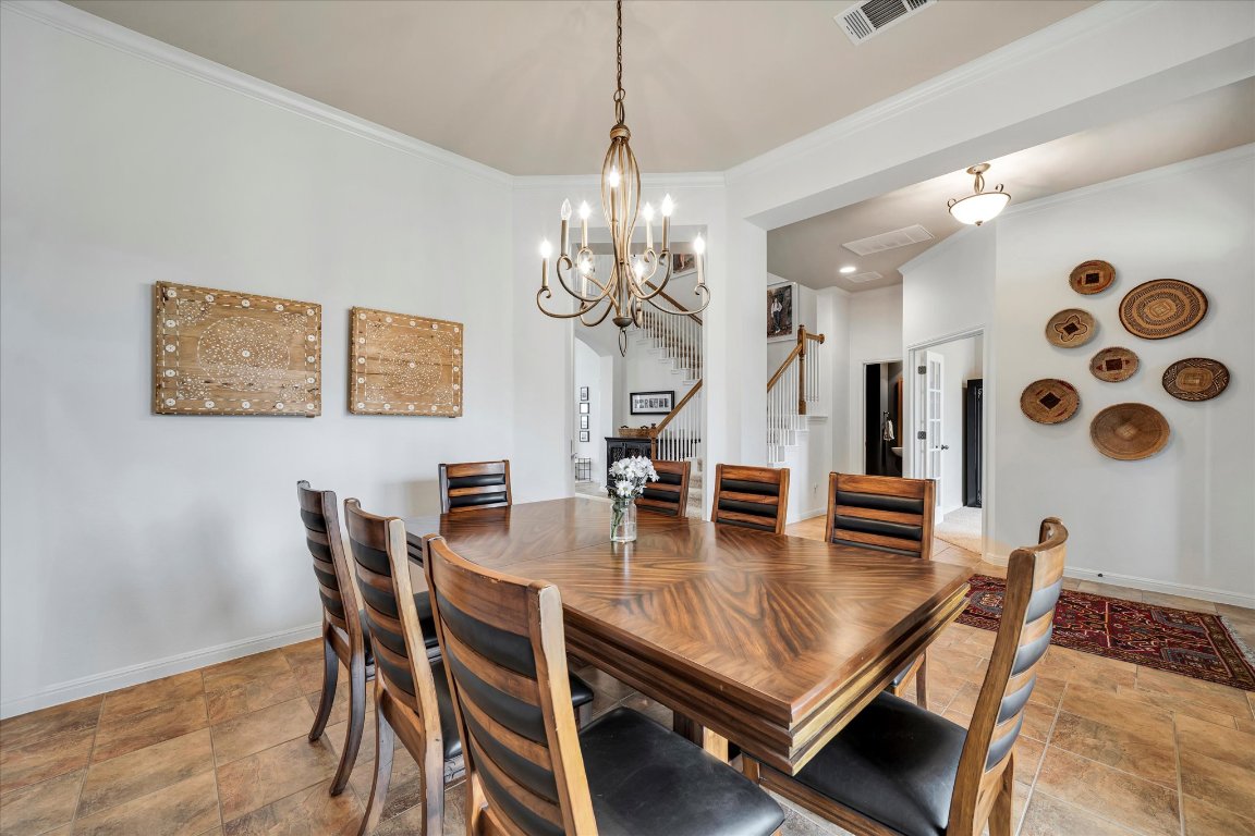 440 Currie Ranch Road Wimberley, TX 78676 - Photo 13 of 40 a view of a dining room with furniture and wooden floor