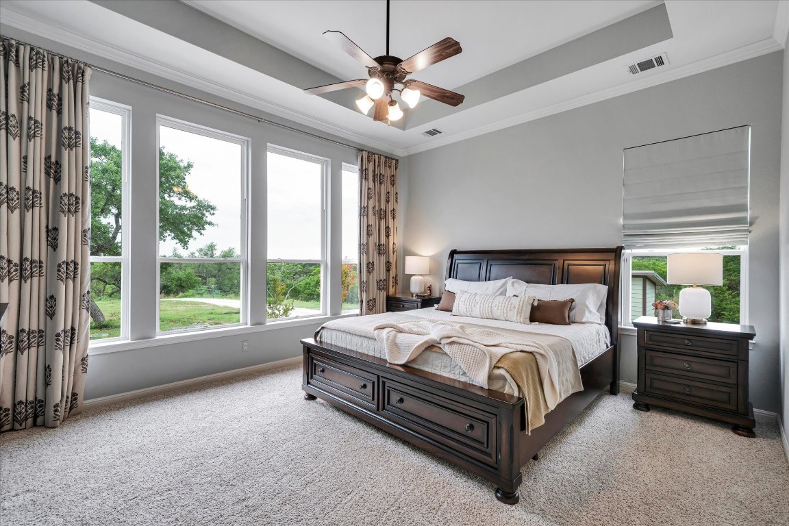 440 Currie Ranch Road Wimberley, TX 78676 - Photo 14 of 40 a bedroom with a bed a large bed and a large window