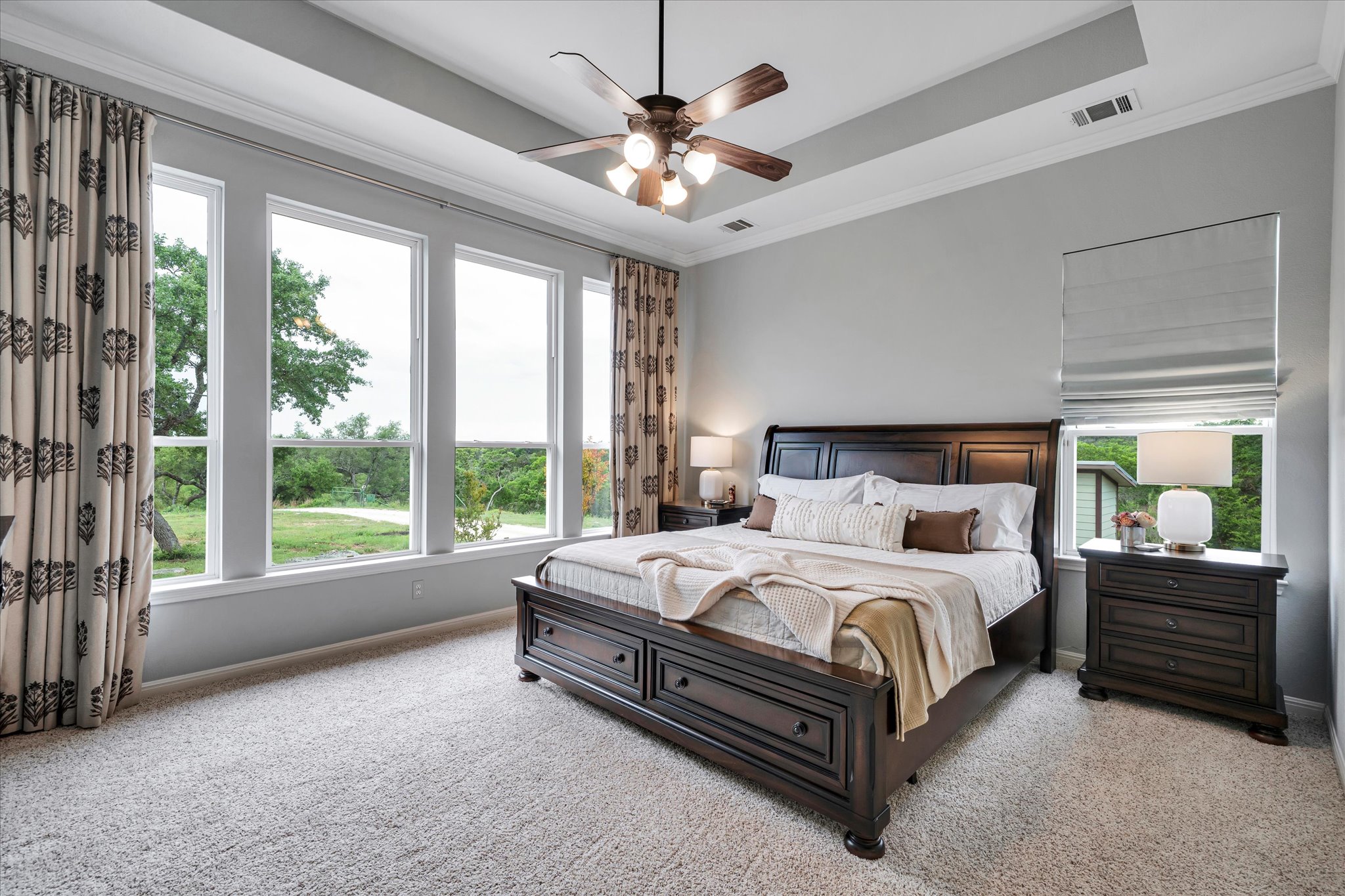 440 Currie Ranch Road Wimberley, TX 78676 - Photo 14 of 40 a bedroom with a bed a large bed and a large window