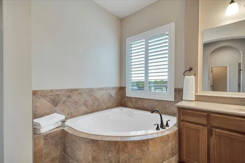 a bath tub sitting in a bathroom next to a window