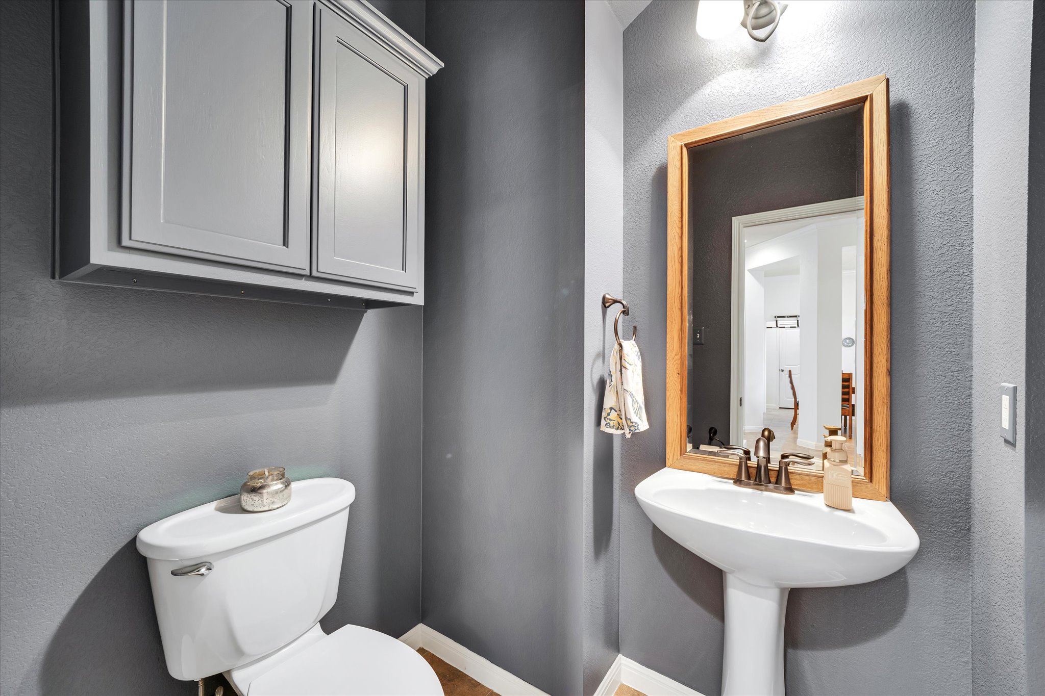 440 Currie Ranch Road Wimberley, TX 78676 - Photo 21 of 40 a bathroom with a toilet sink and mirror