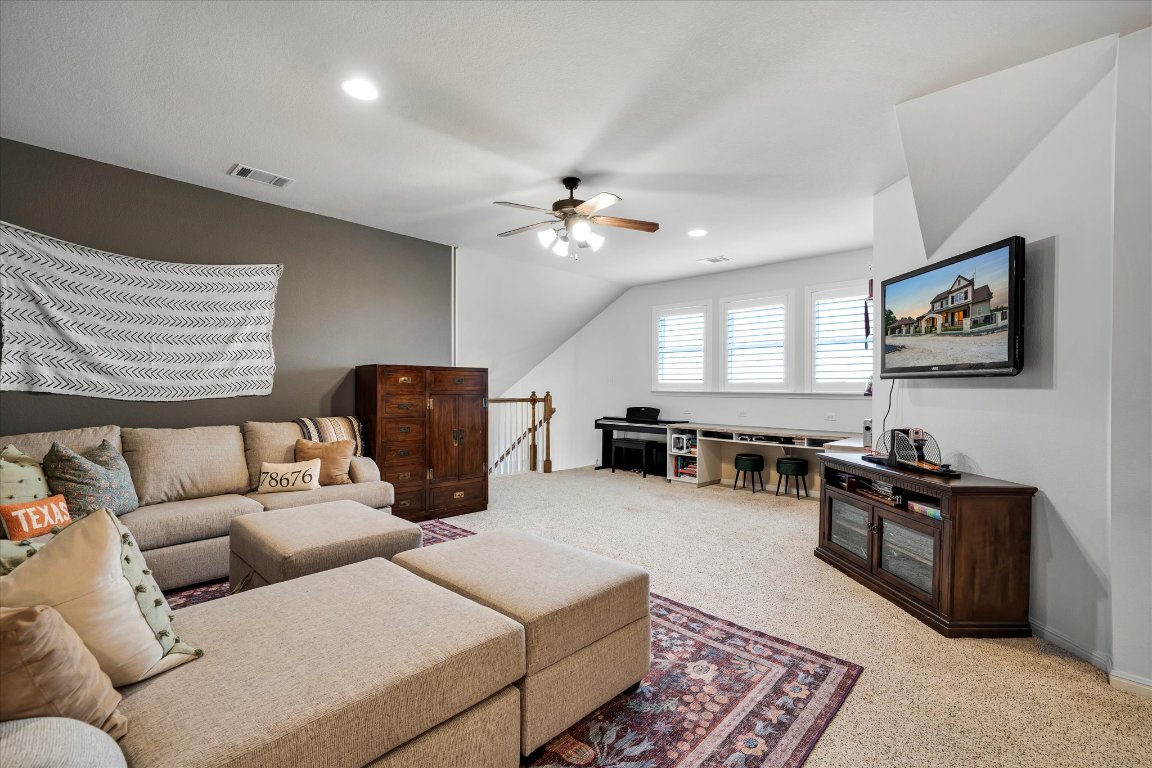 440 Currie Ranch Road Wimberley, TX 78676 - Photo 22 of 40 a living room with furniture ceiling fan and a window