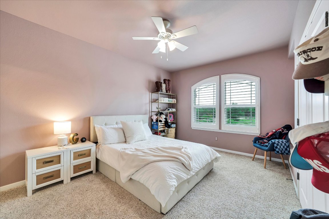 440 Currie Ranch Road Wimberley, TX 78676 - Photo 25 of 40 a spacious bedroom with a bed and a window