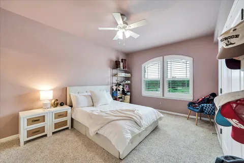 a spacious bedroom with a bed and a window