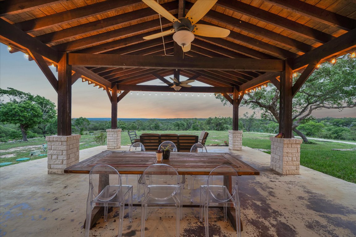 440 Currie Ranch Road Wimberley, TX 78676 - Photo 29 of 40 a patio with yard table and chairs
