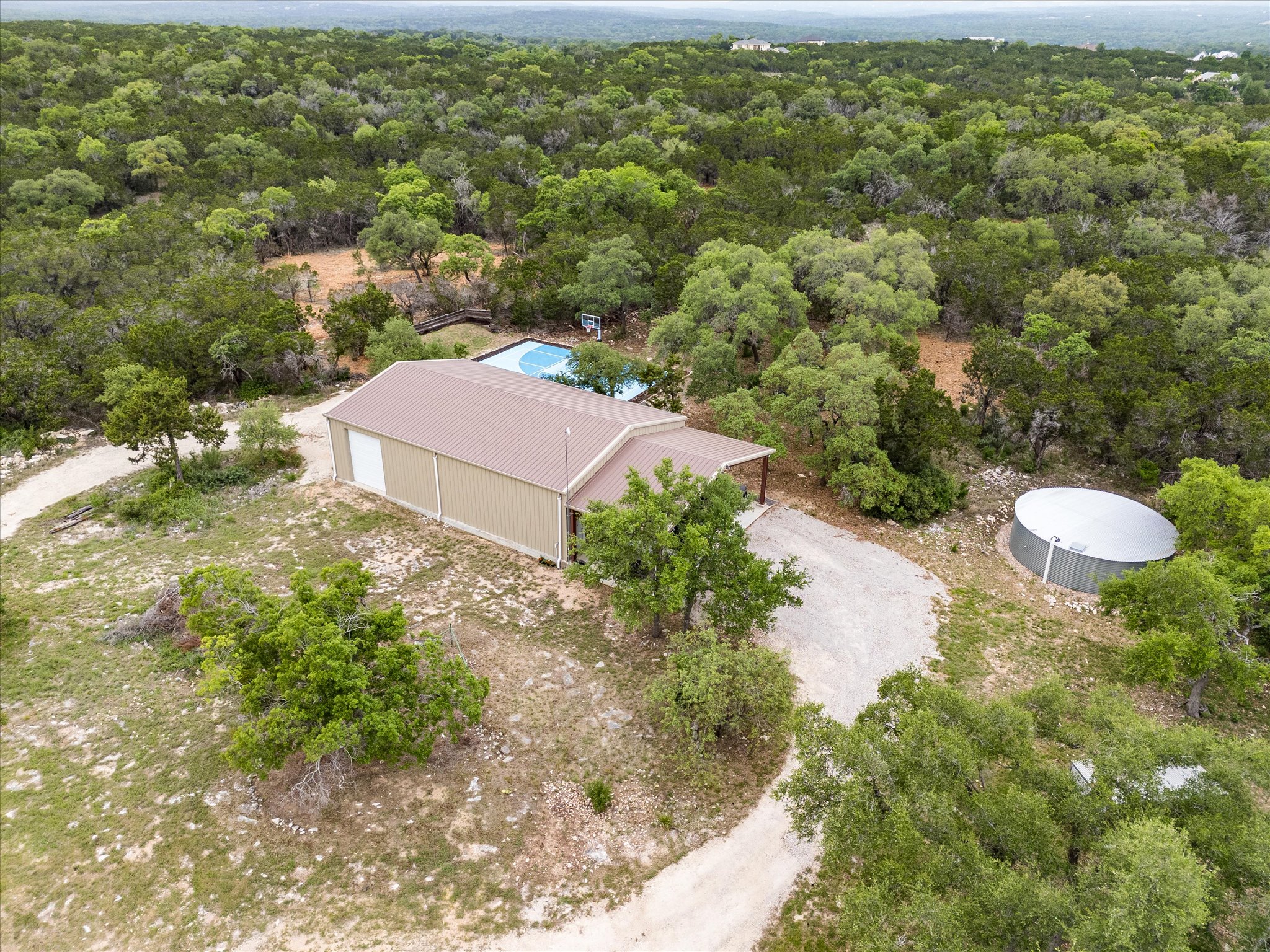 440 Currie Ranch Road Wimberley, TX 78676 - Photo 38 of 40 a view of a house with a yard and street