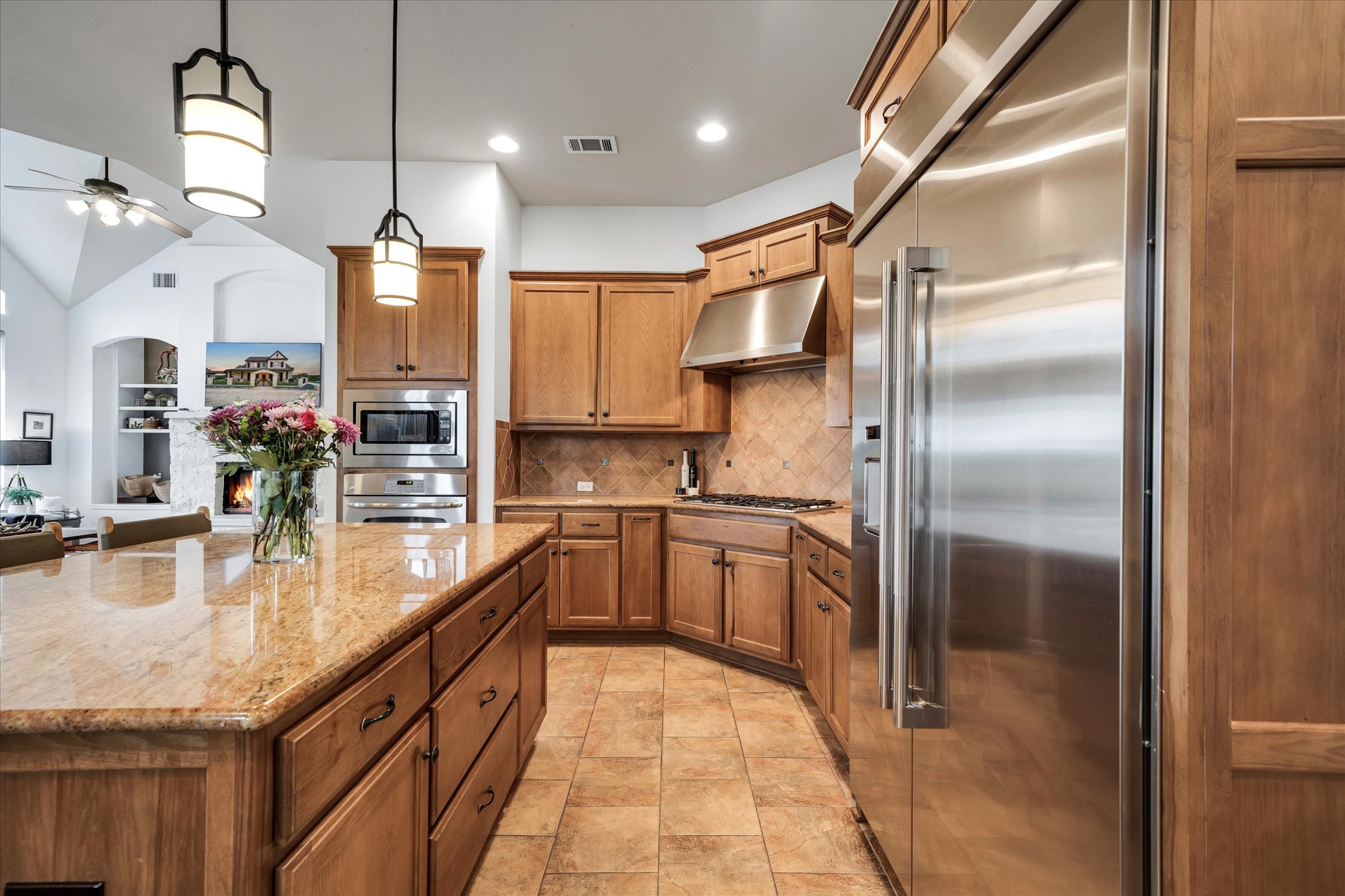 440 Currie Ranch Road Wimberley, TX 78676 - Photo 9 of 40 a kitchen with stainless steel appliances granite countertop a sink a oven and a refrigerator
