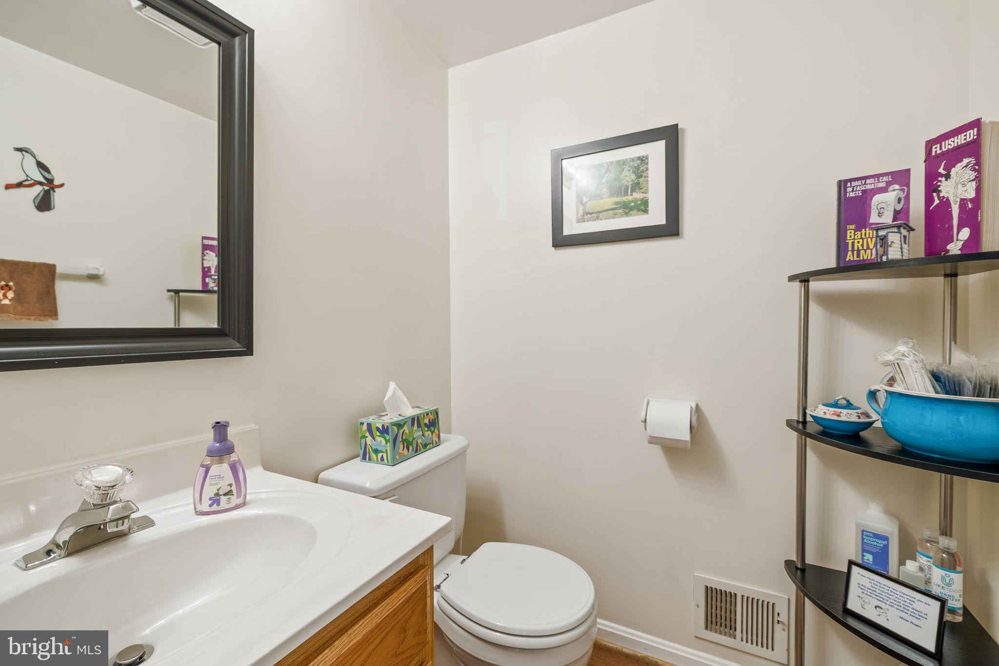 13911 Ruler Court Woodbridge, VA 22193 - Photo 16 of 38 a bathroom with a sink mirror and toilet