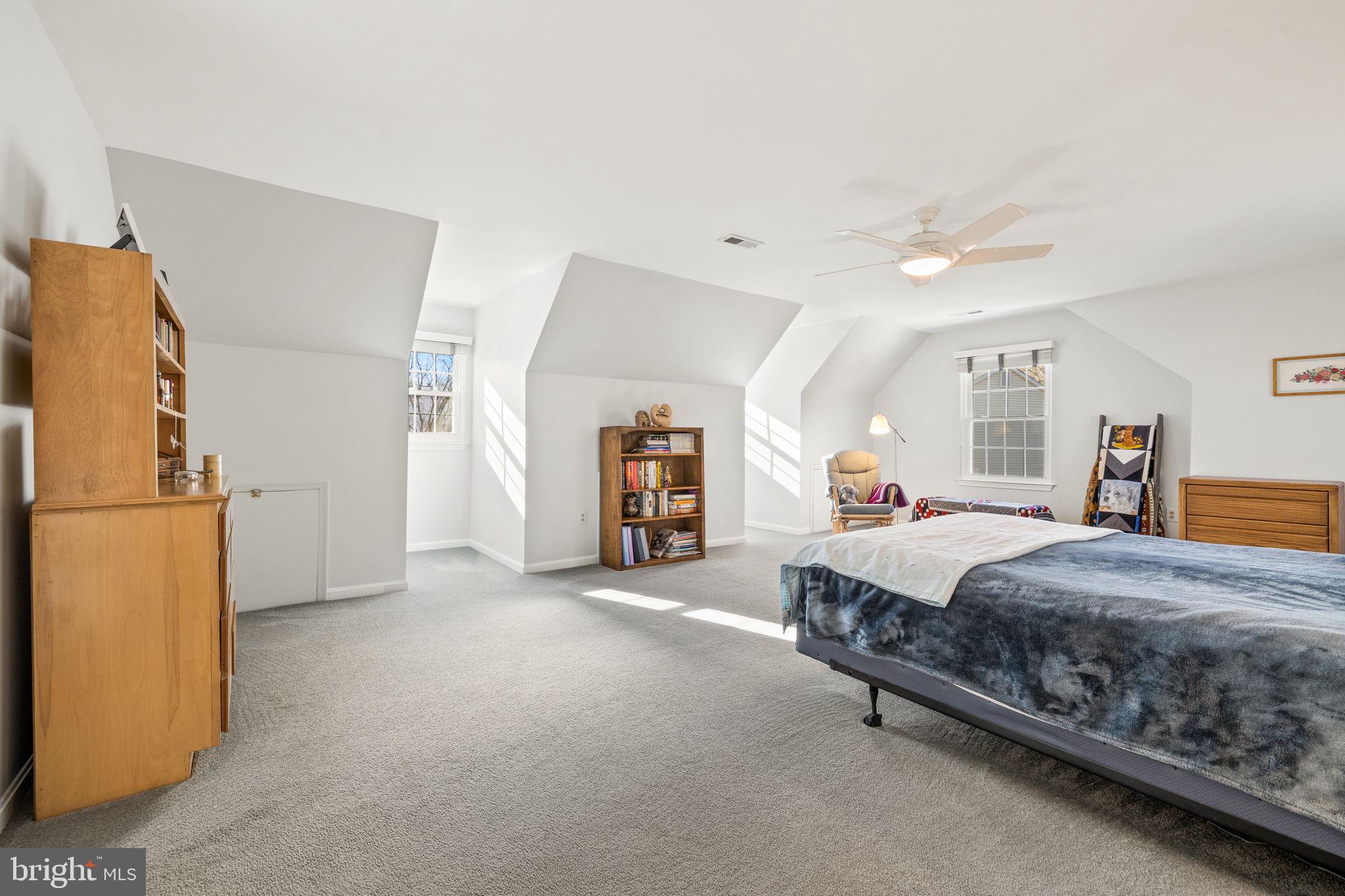 13911 Ruler Court Woodbridge, VA 22193 - Photo 19 of 38 a spacious bedroom with a bed and a refrigerator