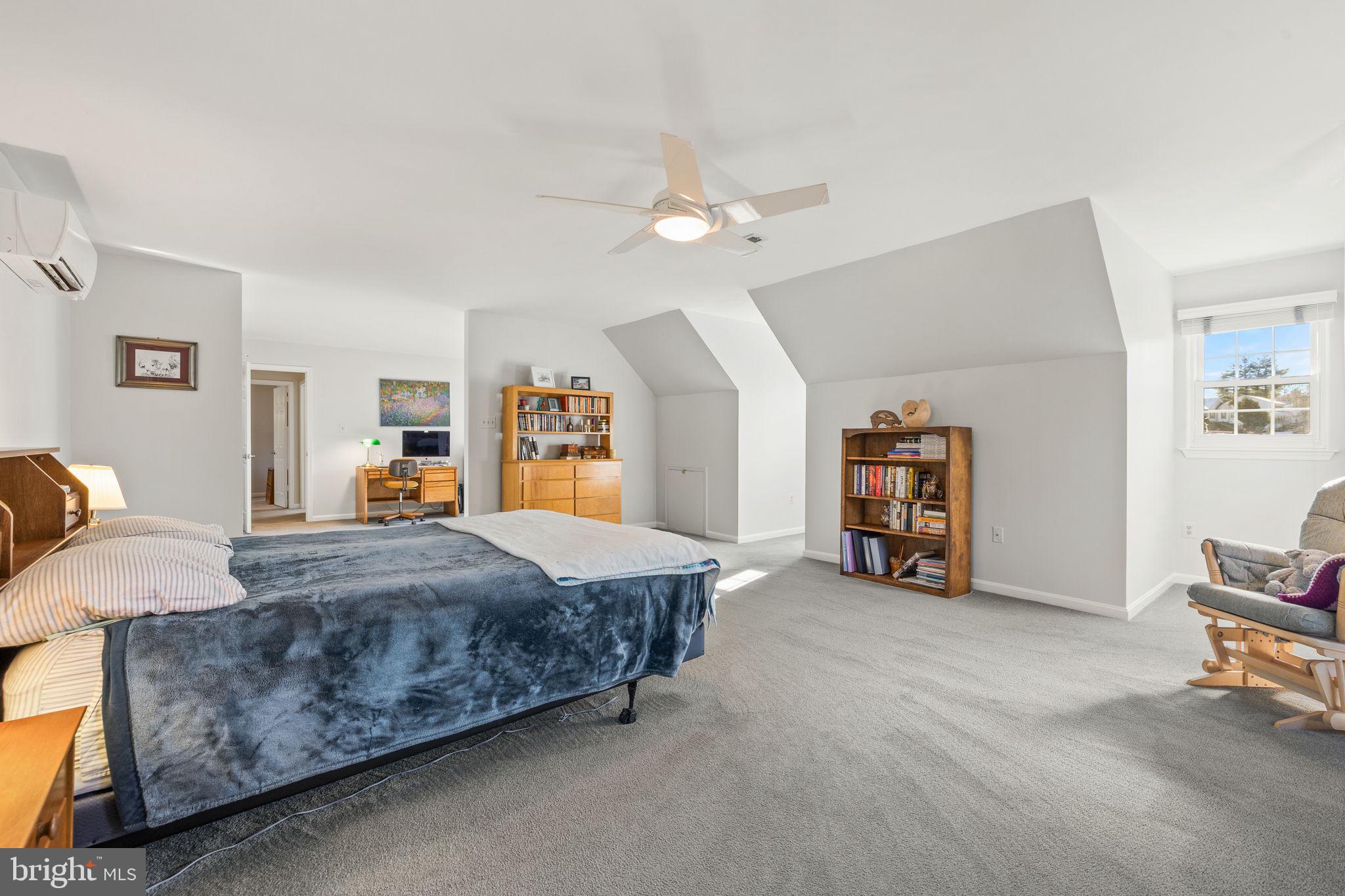 13911 Ruler Court Woodbridge, VA 22193 - Photo 21 of 38 a spacious bedroom with a bed and a chandelier