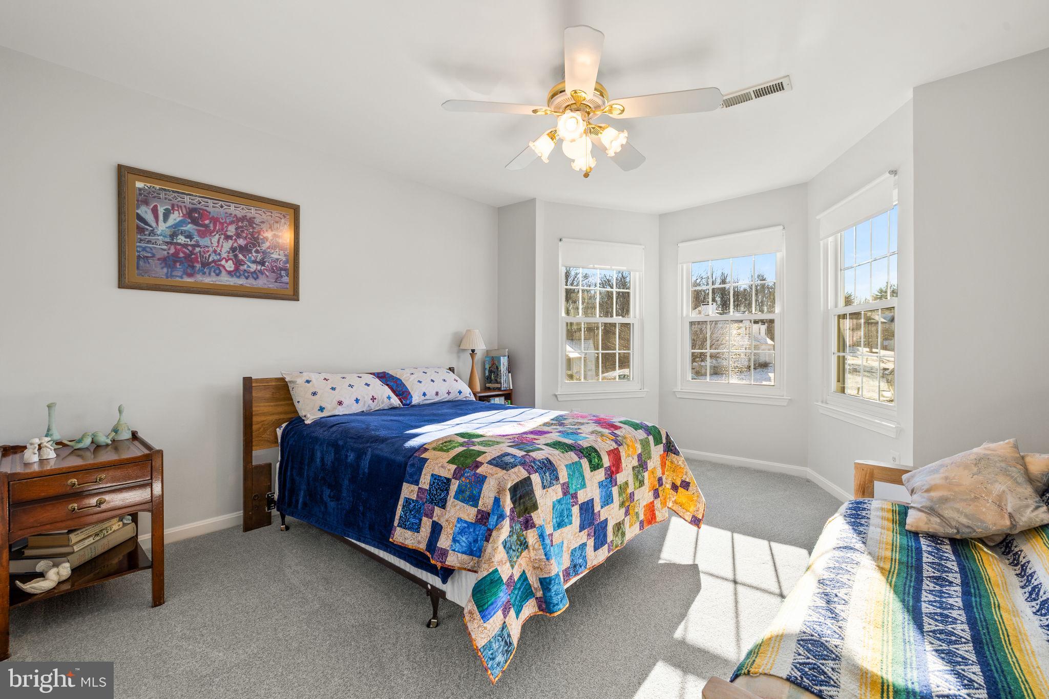 13911 Ruler Court Woodbridge, VA 22193 - Photo 23 of 38 a bedroom with a bed and a chandelier